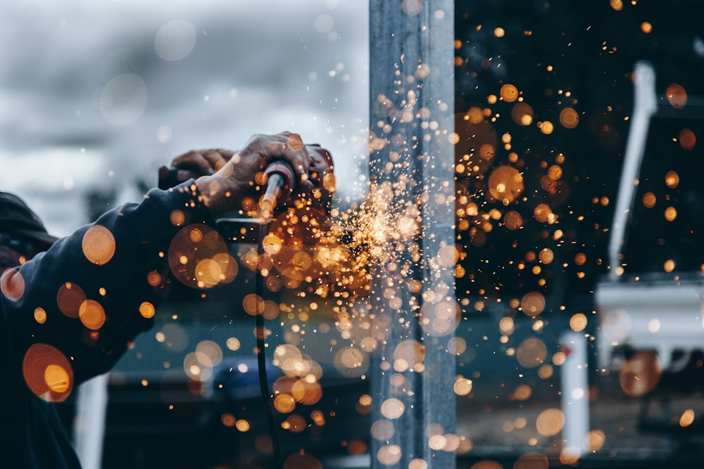 Sparks flying while metal is ground at a workbench