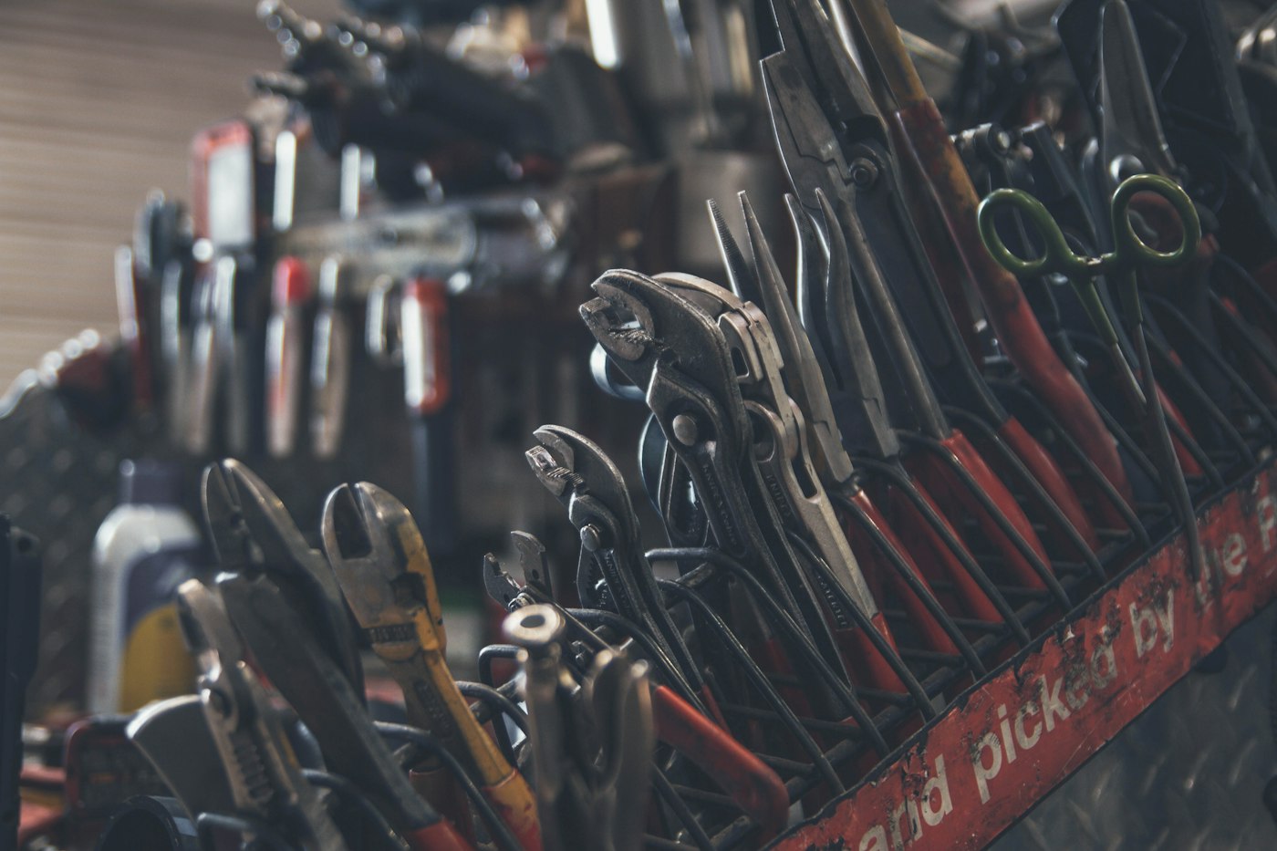 Hand tools hanging on a workshop rack